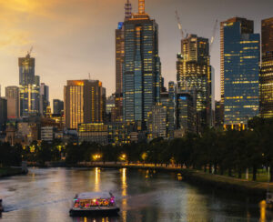 Landscape of Melbourne City over Maribyrnong River and Footscray Park. Crowded modern office buildings in Melbourne\'s CBD in sunset.