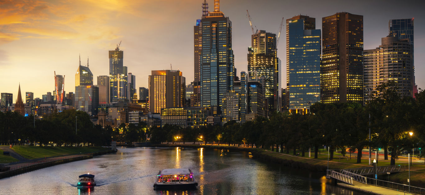 Landscape of Melbourne City over Maribyrnong River and Footscray Park. Crowded modern office buildings in Melbourne\'s CBD in sunset.