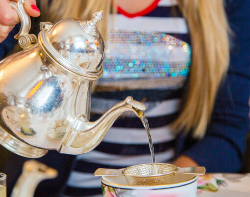 Girl enjoying classical London afternoon tea with english breakfast and snacks.