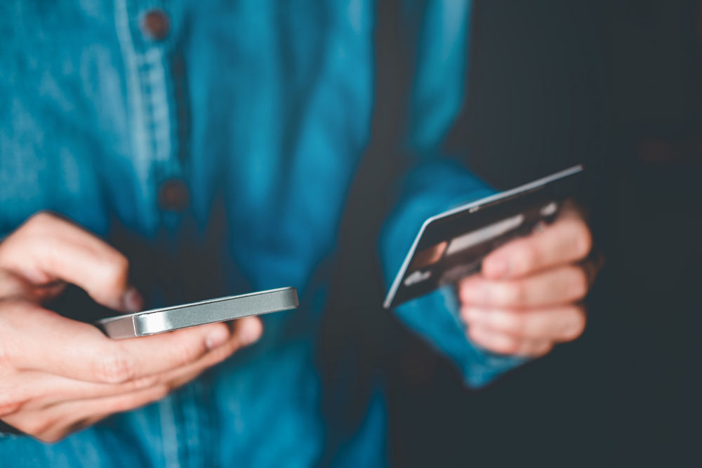 man on phone with credit card