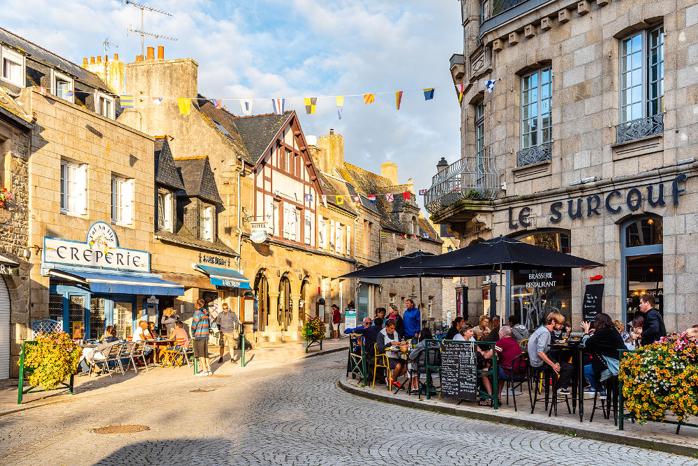 People enjoying dinners in restaurants and creperies in the old centre of the town.