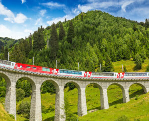 Train on famous landwasser Viaduct bridge.The Rhaetian Railway section from the Albula/Bernina area (the part from Thusis to Tirano including St Moritz) was added to the list of UNESCO World Heritage Sites Switzerland Europe.