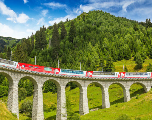 Train on famous landwasser Viaduct bridge.The Rhaetian Railway section from the Albula/Bernina area (the part from Thusis to Tirano including St Moritz) was added to the list of UNESCO World Heritage Sites Switzerland Europe.