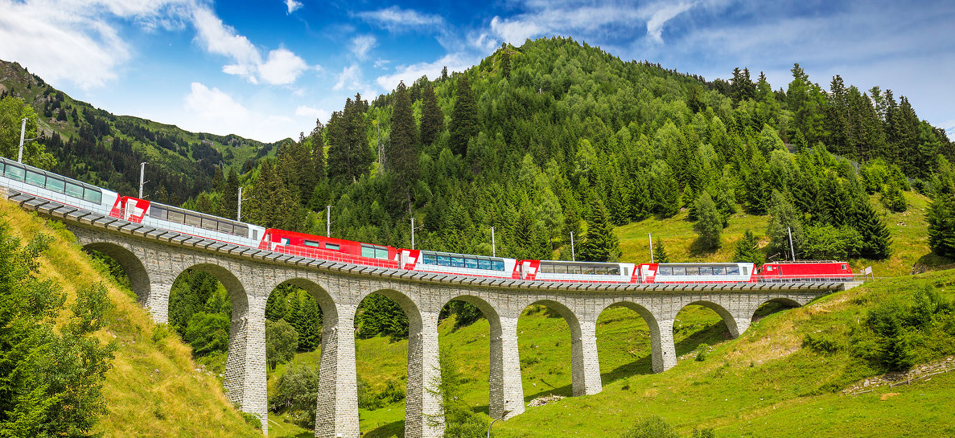 Train on famous landwasser Viaduct bridge.The Rhaetian Railway section from the Albula/Bernina area (the part from Thusis to Tirano including St Moritz) was added to the list of UNESCO World Heritage Sites Switzerland Europe.