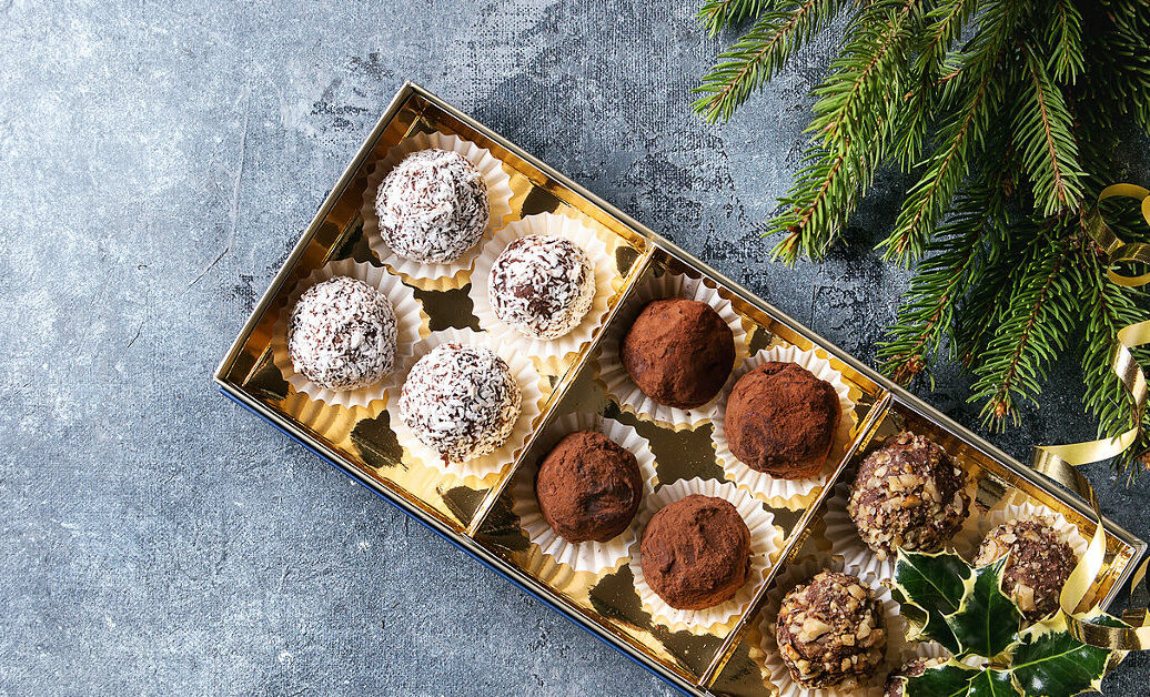 Variety of homemade dark chocolate truffles with cocoa powder