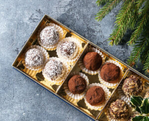 Variety of homemade dark chocolate truffles with cocoa powder