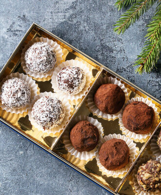 Variety of homemade dark chocolate truffles with cocoa powder