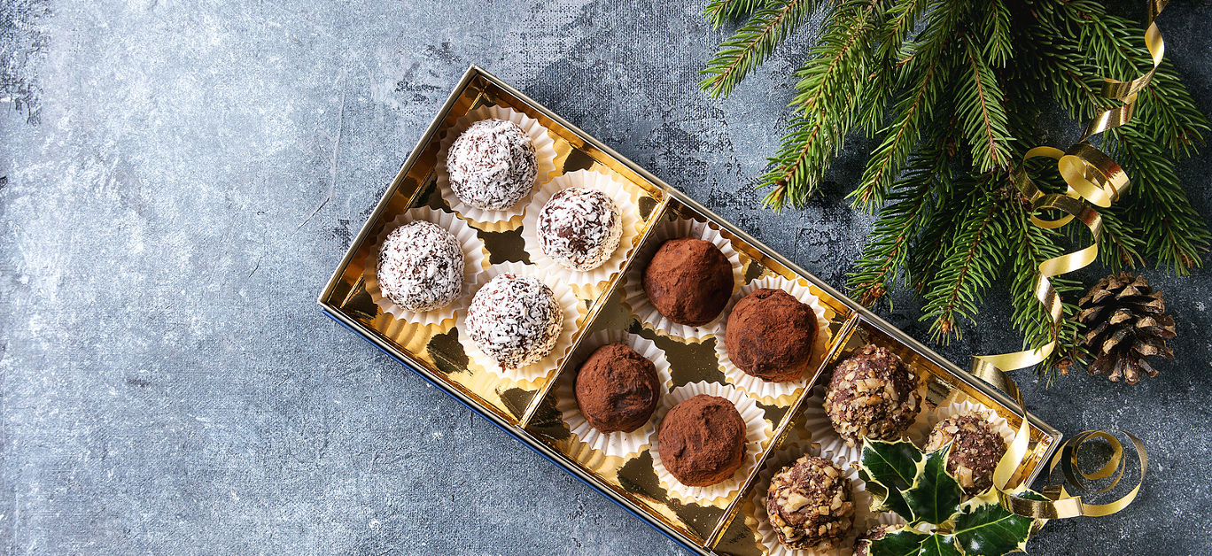 Variety of homemade dark chocolate truffles with cocoa powder