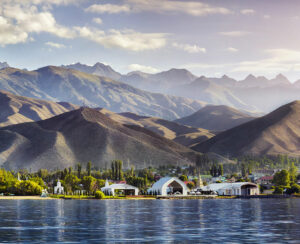 View to Ruh Ordo cultural complex near Issyk Kul lake at mountains background in Cholpon Ata Kyrgyzstan