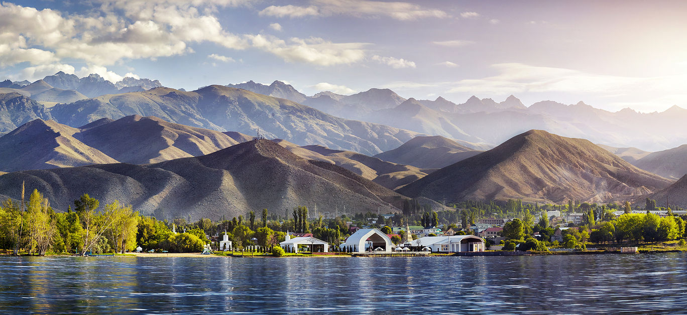 View to Ruh Ordo cultural complex near Issyk Kul lake at mountains background in Cholpon Ata Kyrgyzstan