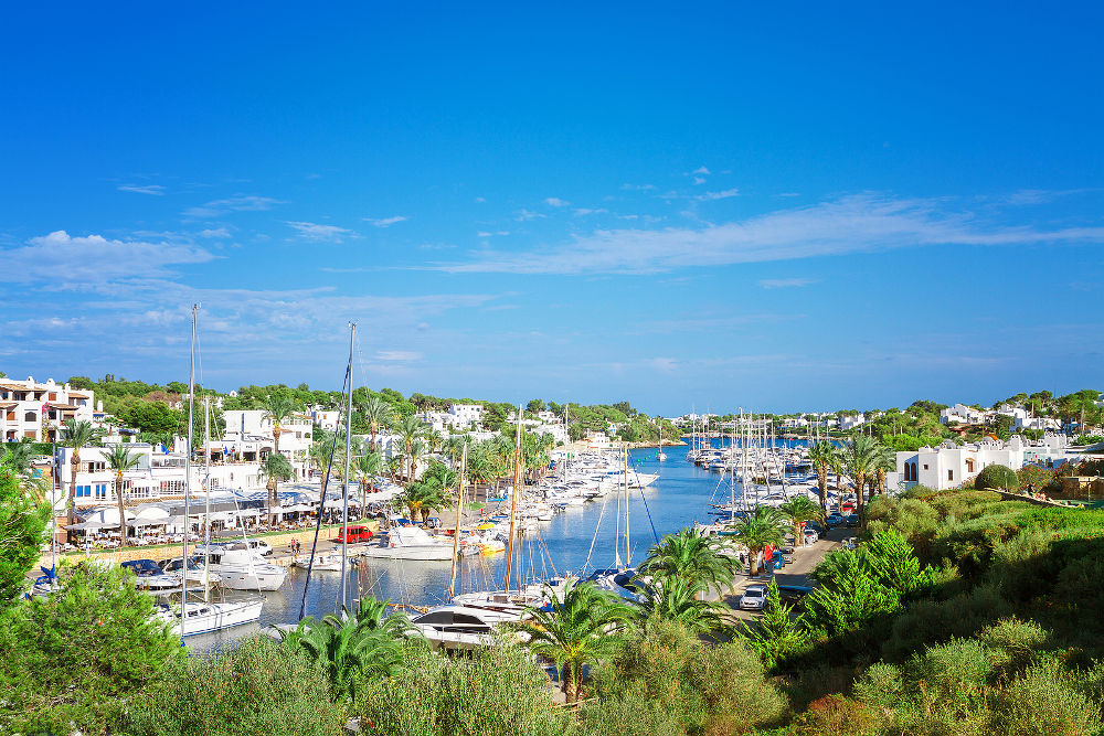 Panoramic view of the Cala D'Or yacht marina harbor with recreational boats. Mallorca, Spain