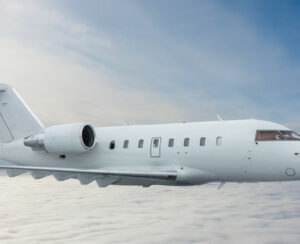 White private jet fly in the air above the clouds