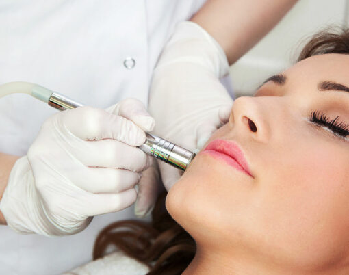 Woman getting laser face treatment in medical spa center, skin rejuvenation concept