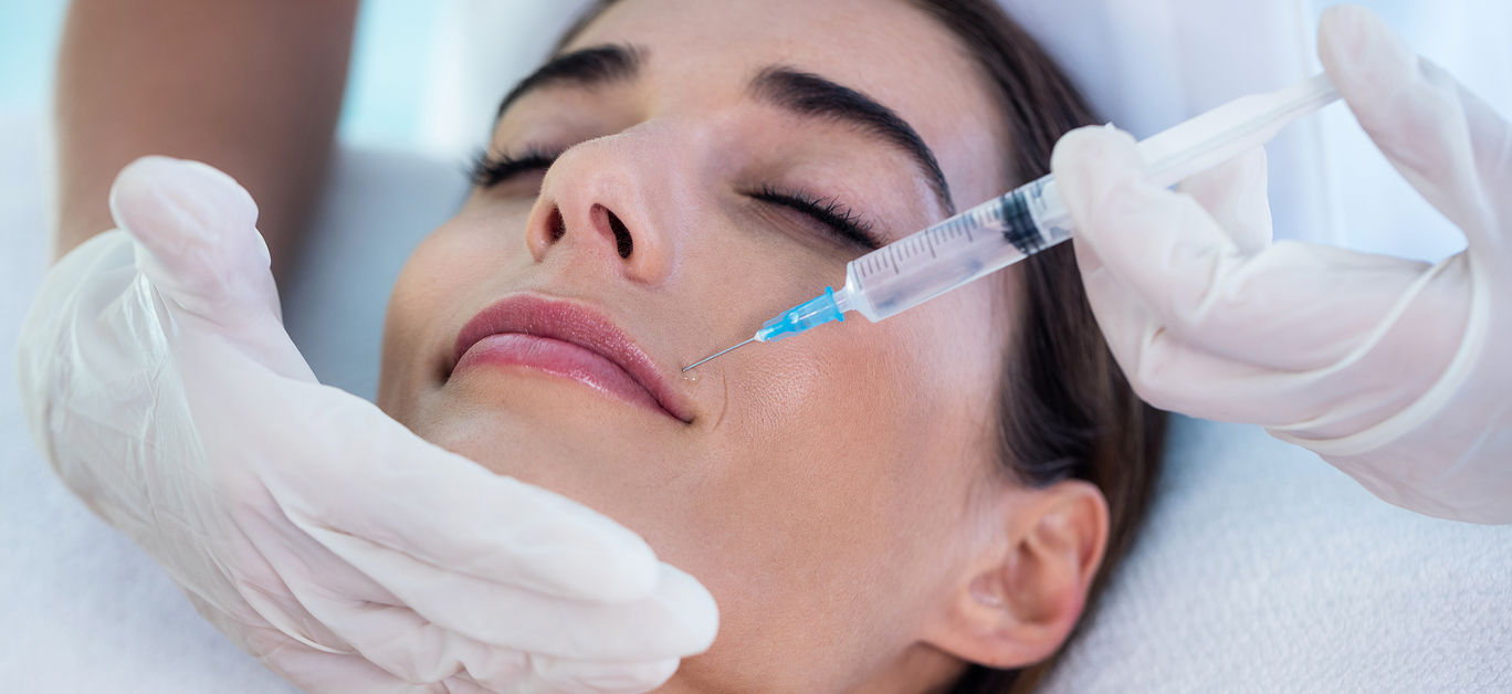 Woman receiving botox injection at spa