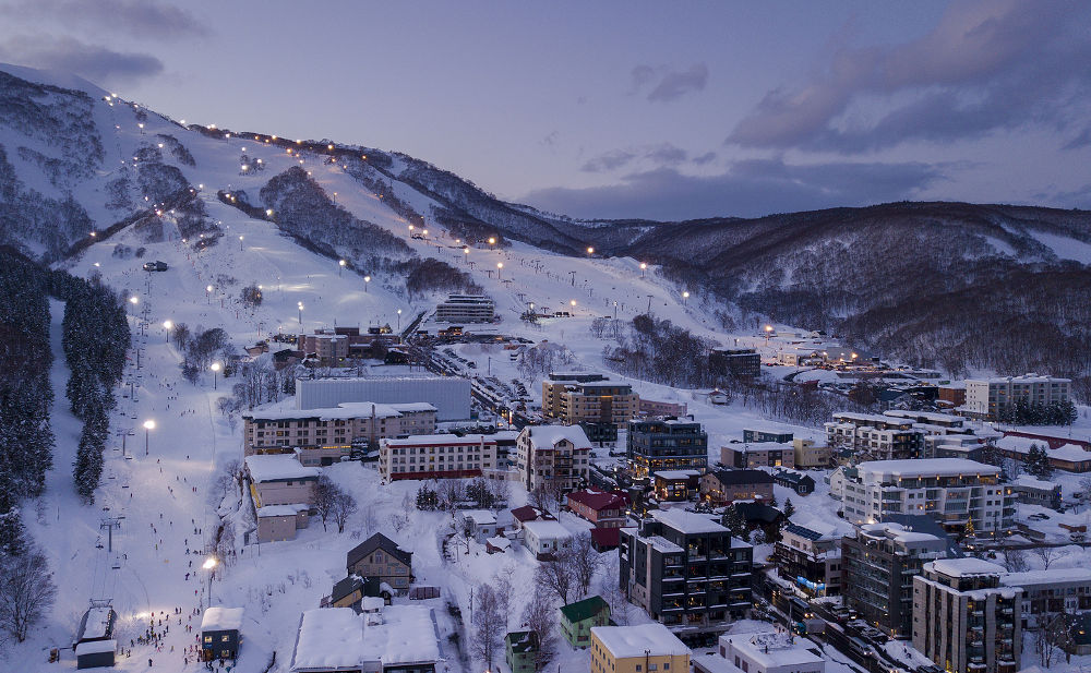 Aerial view at dusk of night skiing in Niseko Village