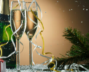 Festive Christmas composition with champagne glasses, gift and snow