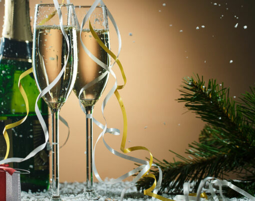 Festive Christmas composition with champagne glasses, gift and snow