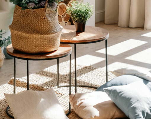 Interior of bright living room in scandinavian eco style with coffee table and pillows