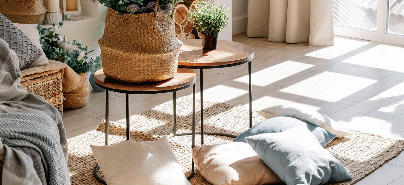 Interior of bright living room in scandinavian eco style with coffee table and pillows