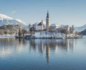 Lake Bled with Bled Castle (Blejski grad) and Julian Alps in the background on a beautiful sunny day in winter, Slovenia