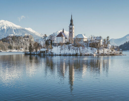 Lake Bled with Bled Castle (Blejski grad) and Julian Alps in the background on a beautiful sunny day in winter, Slovenia