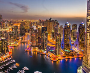 Dubai Marina at Blue hour, Glittering lights and tallest skyscrapers during a clear evening with Blue sky.