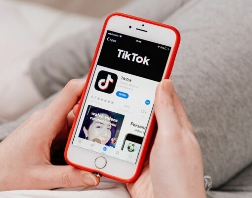 tiktok. iPhone in hand. installing app on a smartphone.