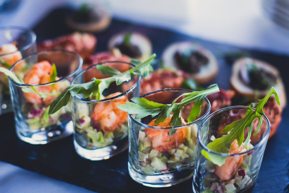 Beautifully decorated catering banquet table with different food snacks and appetizers on corporate christmas birthday party event or wedding celebration