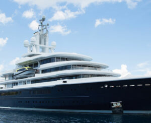 Gigantic big and large luxury mega yacht with helicopter landing place on the blue ocean. Investment for millionaires.