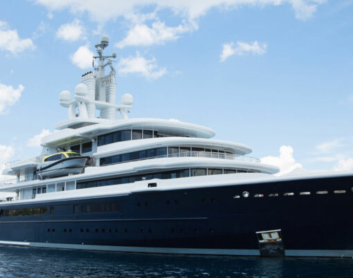 Gigantic big and large luxury mega yacht with helicopter landing place on the blue ocean. Investment for millionaires.