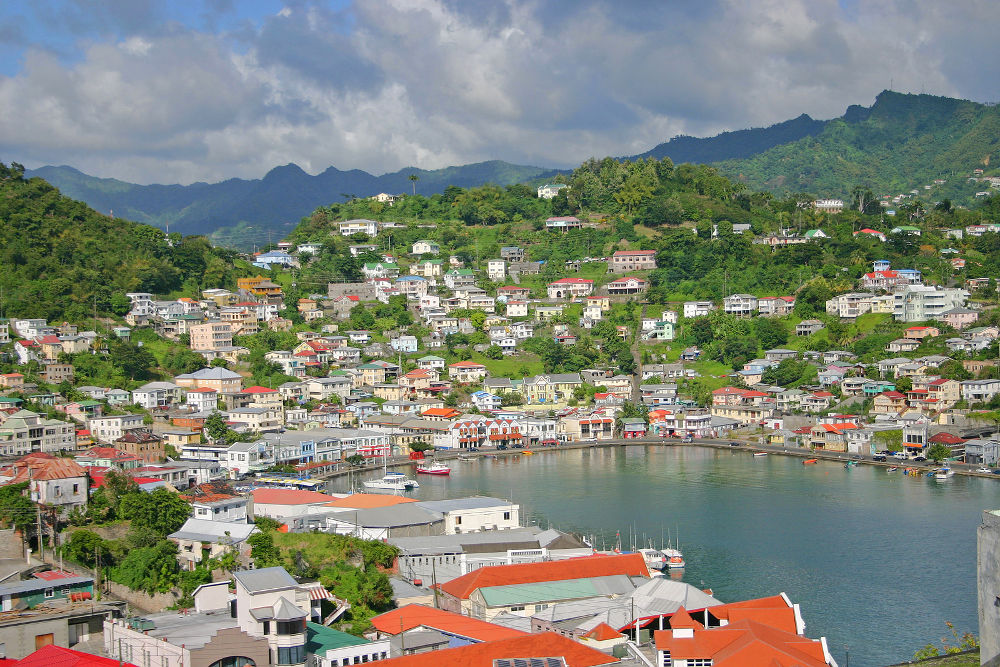 colorful houses dot the hillsides around this harbor in St. Georges, Grenada, in the Caribbean