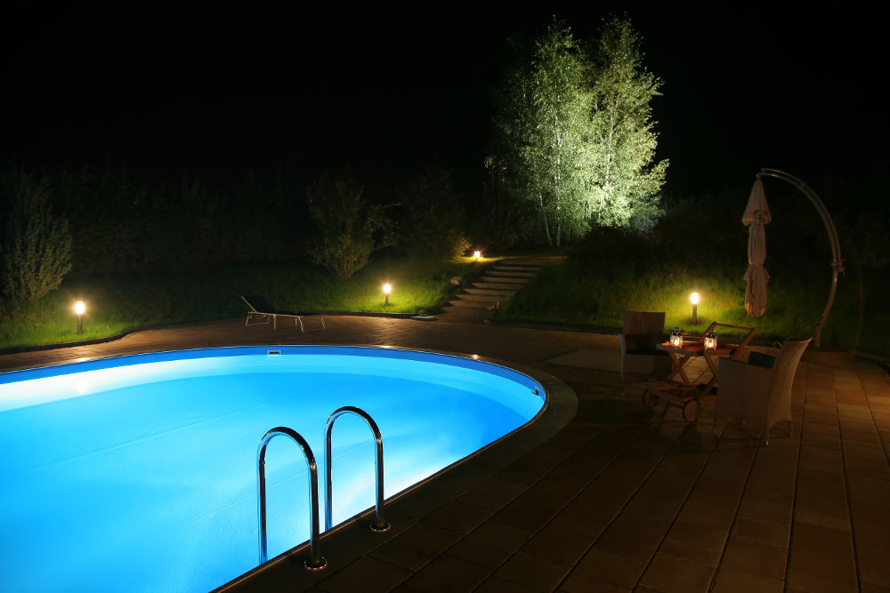 swimming pool outdoors at night with lights